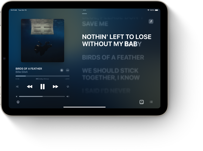 iPad mini, landscape orientation, displaying Apple Music with song lyrics.